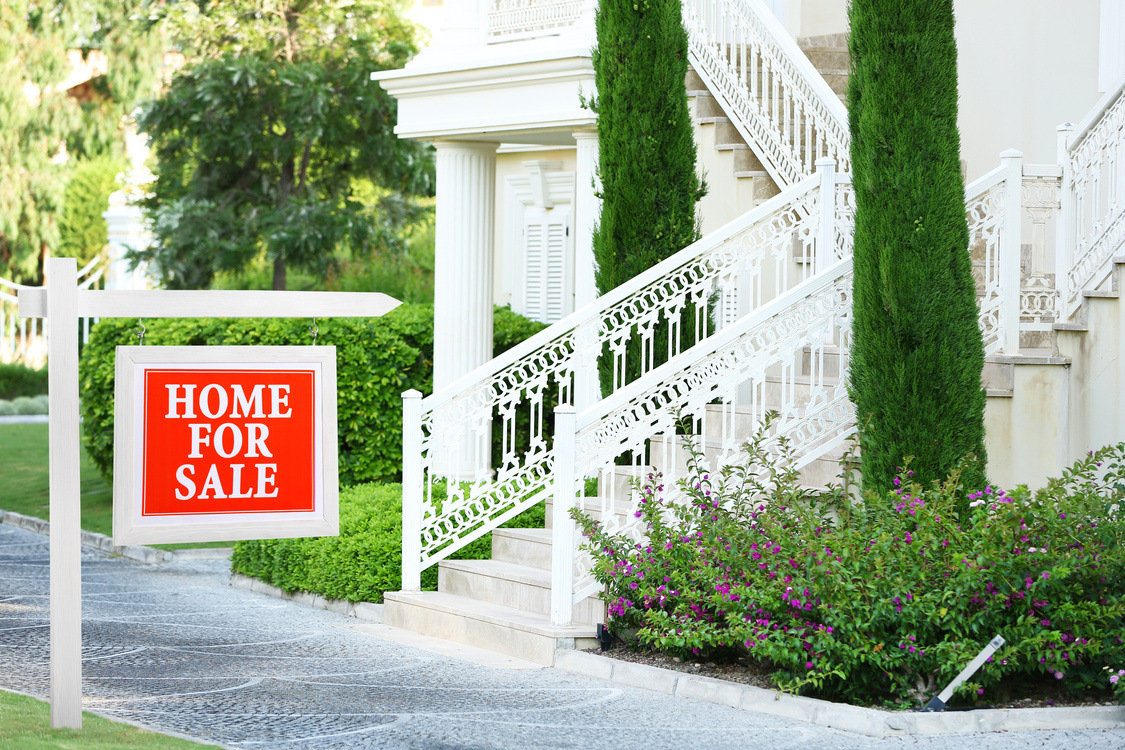 White Mansion with Home for Sale Sign